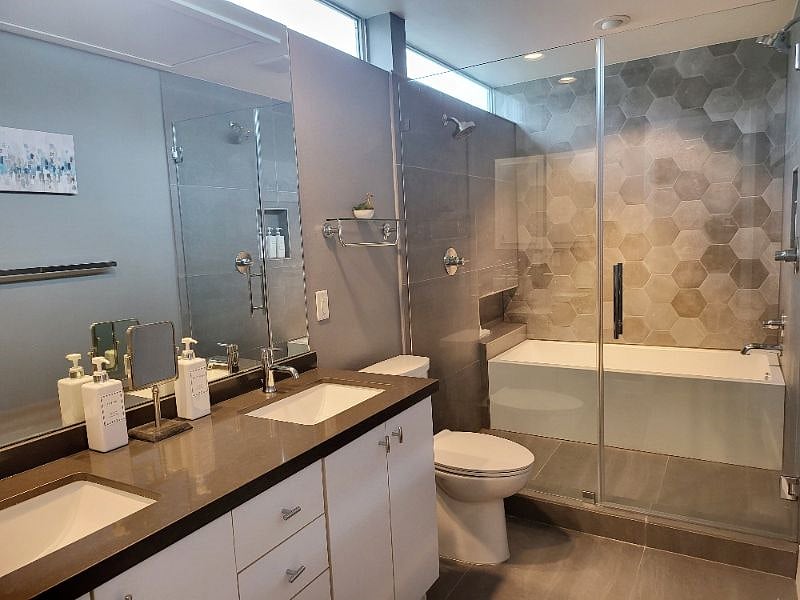 Tastefully renovated master bathroom with enclosed tub and shower