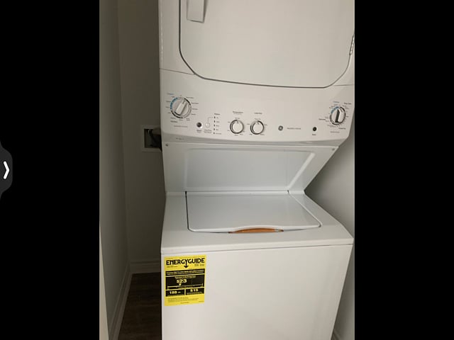 Washer Dryer fully stocked with a few detergents, etc also stowed ironing board and iron.