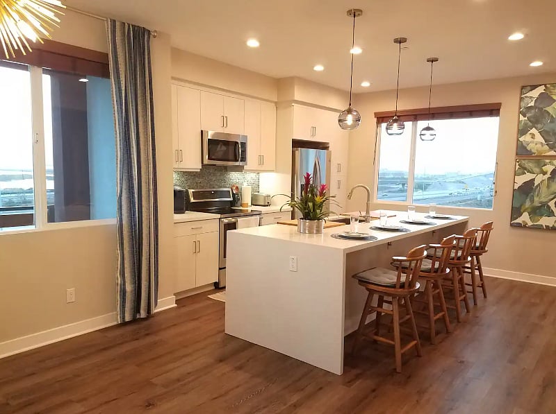 Stocked with kitchen essentials, Keurig coffee machine, and 10' quartz island