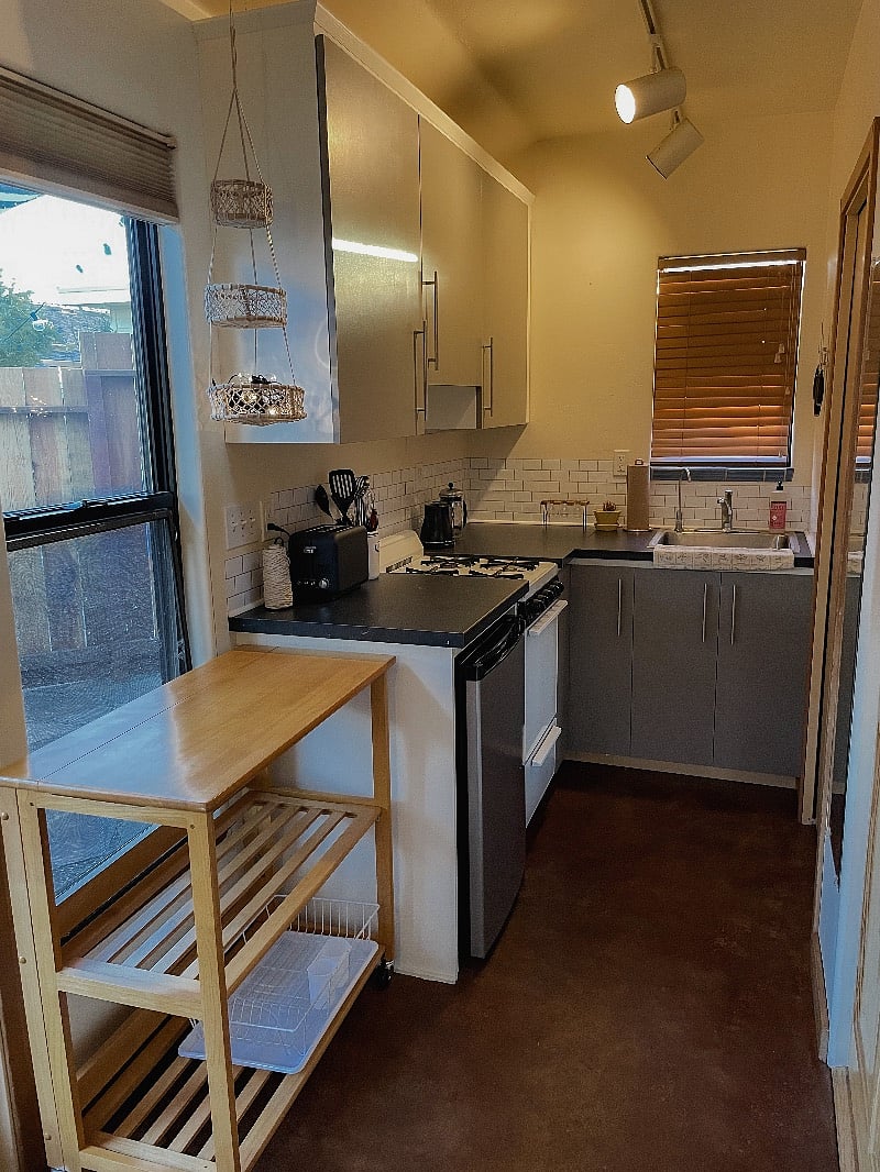 Full kitchen with everything you need. Kitchen cart on wheels doubles as dining table. Stools provided too