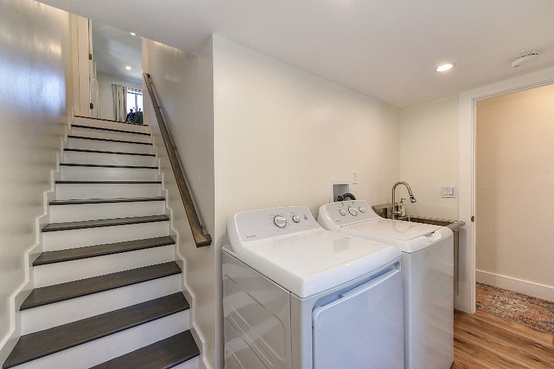 Walk through laundry room to 3rd bedroom upstairs.