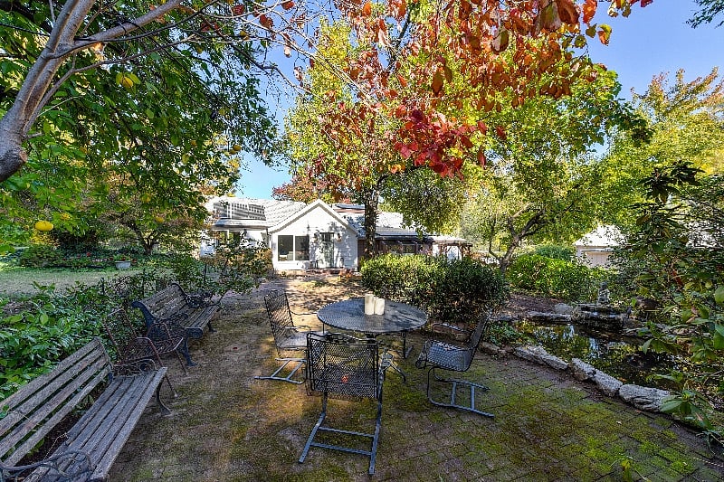 Outdoor seating area near small pond.