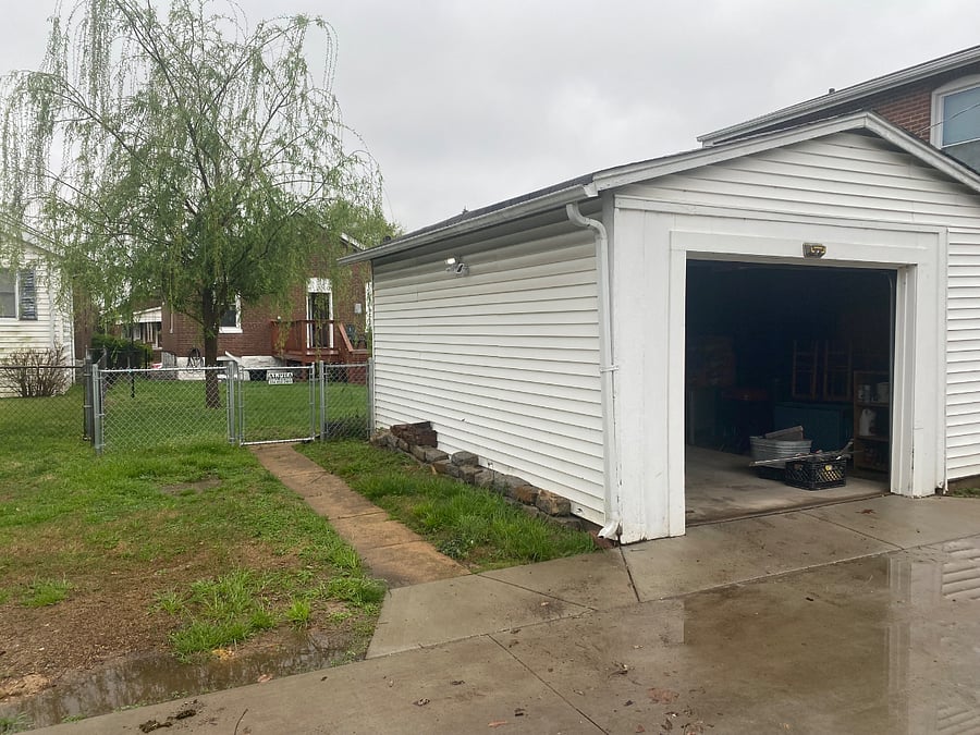 Additional parking spot in grass next to garage. There is a motion sensor light on side of garage