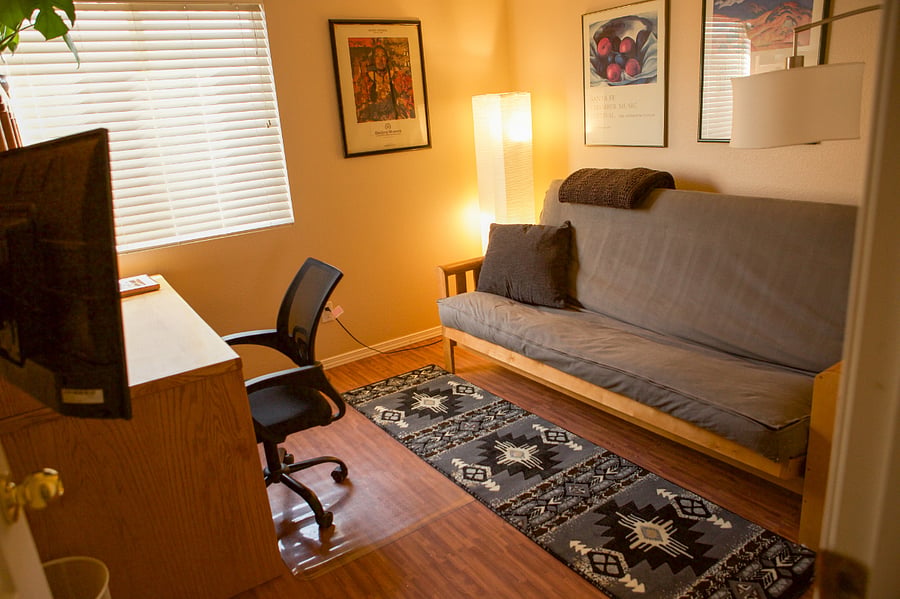 Your Office with futon desk and second monitor / tv.