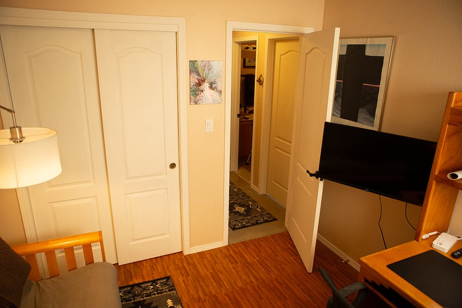 Your Office with futon desk and second monitor / tv.