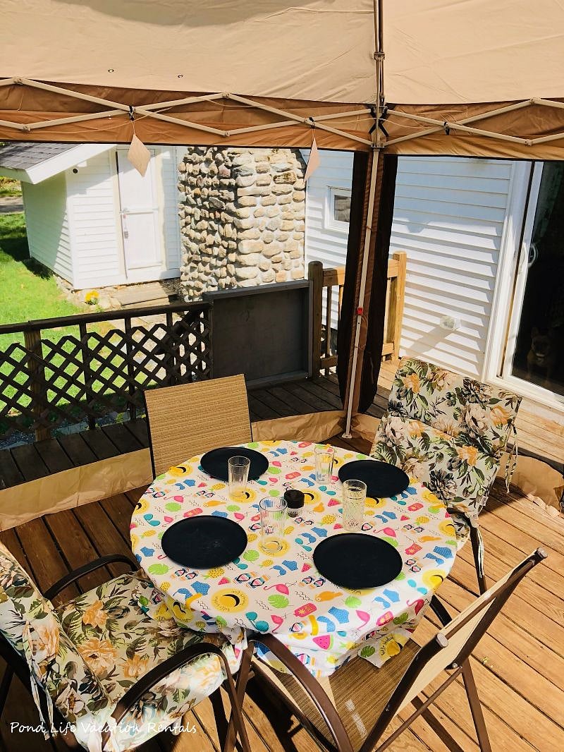 Outdoor sitting area under screened canopy