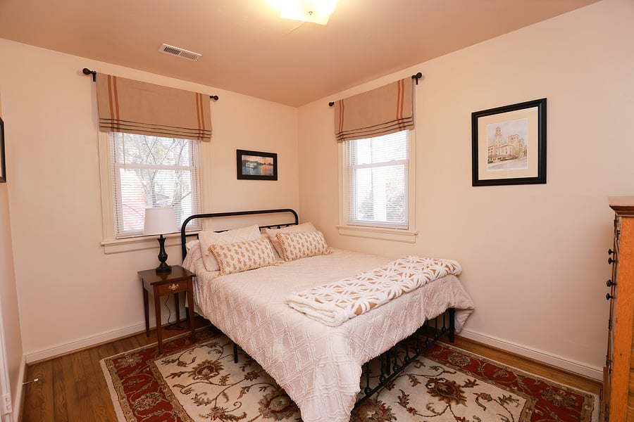 Bedroom 3 has a queen size bed, a spacious, antique quarter sawn oak dresser and closet with hangers.  The bedroom has been appointed with elegant custom window treatments and a beautiful oriental rug.