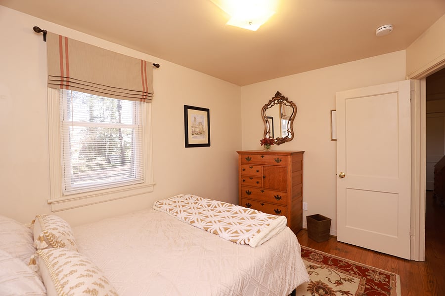 Bedroom 3 has a queen size bed, a spacious, antique quarter sawn oak dresser and closet with hangers.  The bedroom has been appointed with elegant custom window treatments and a beautiful oriental rug.