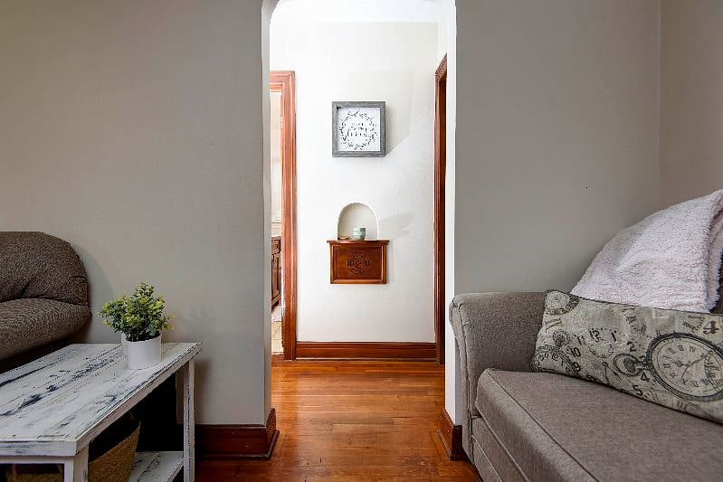 View from the living room into the hall way leading to two bedrooms and bath