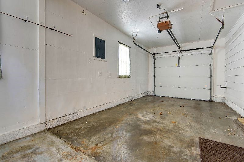 Single car garage with garage door opener.