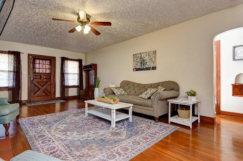 Warm wood floors, ceiling fan, a fireplace, a big-screen television, and comfy furnishings invite you to relax and unwind.