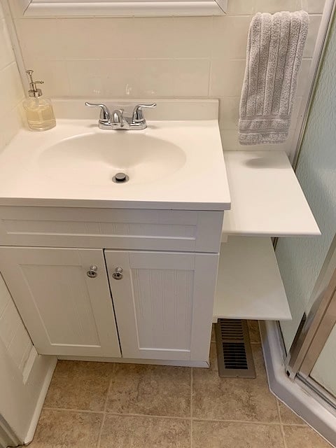 extra storage shelving both next to and above vanity