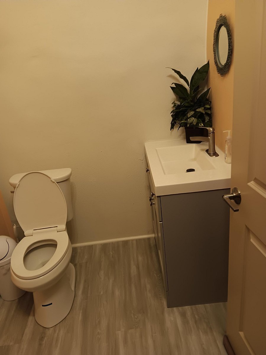 Upstairs half bath down the hall from the kitchen (upper entrance level).