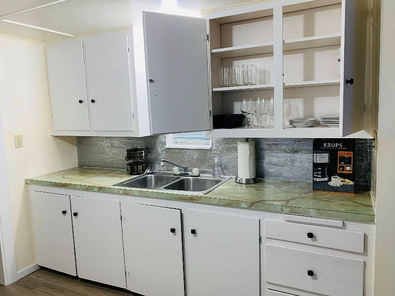 Wine glass, coffee maker, coffee mugs, cutting board, spics, pots/pans, baking pan, plates, bowls and utensils.  Everything you need.  