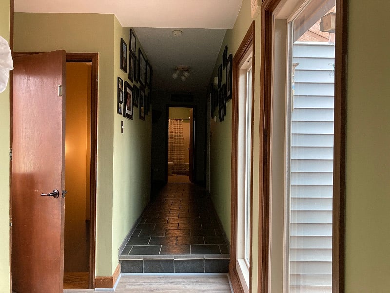 Hallway going back to the bathrooms and bedrooms. Door to the left goes down to the basement