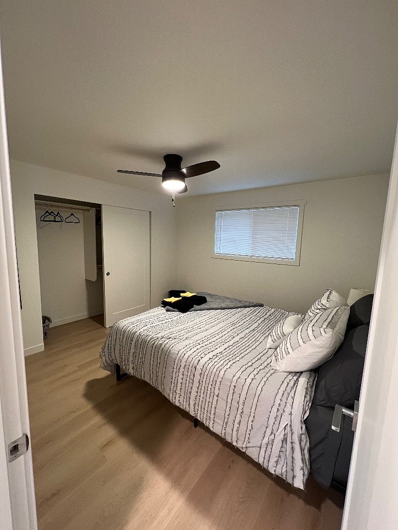 Bedroom 1 features a queen size bed, a large closet with ample storage space, ceiling fan/light