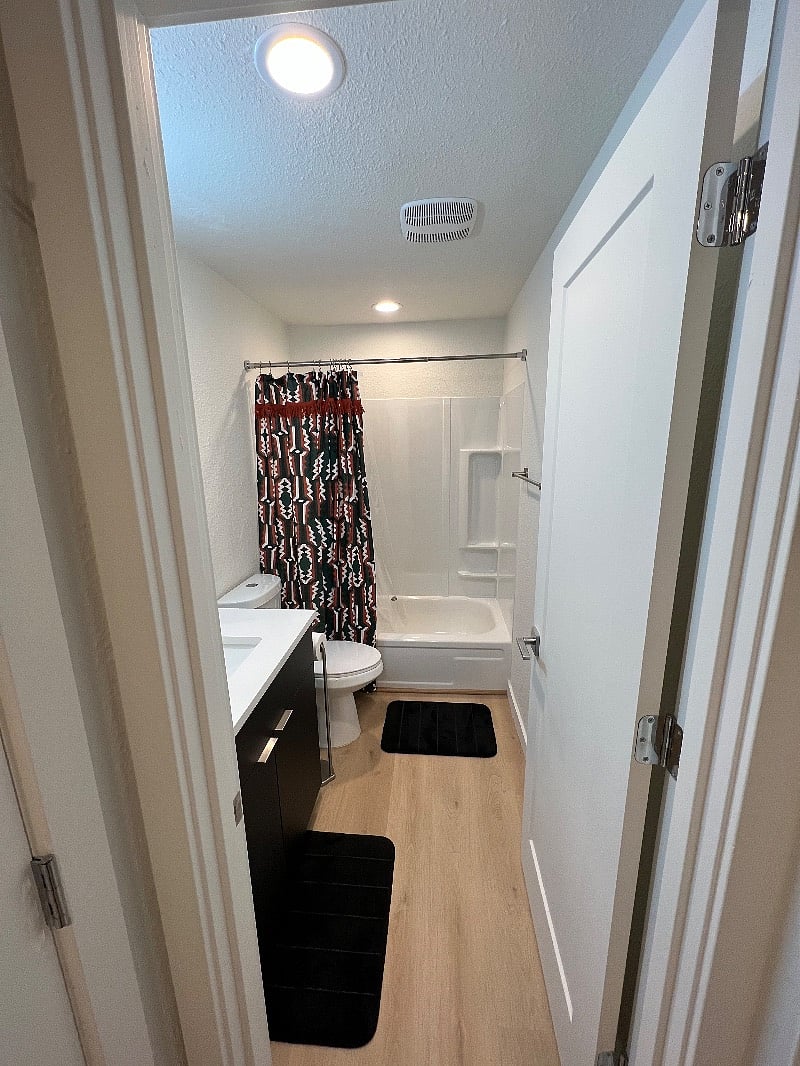 Updated bathroom with large sink, toilet, and shower/tub