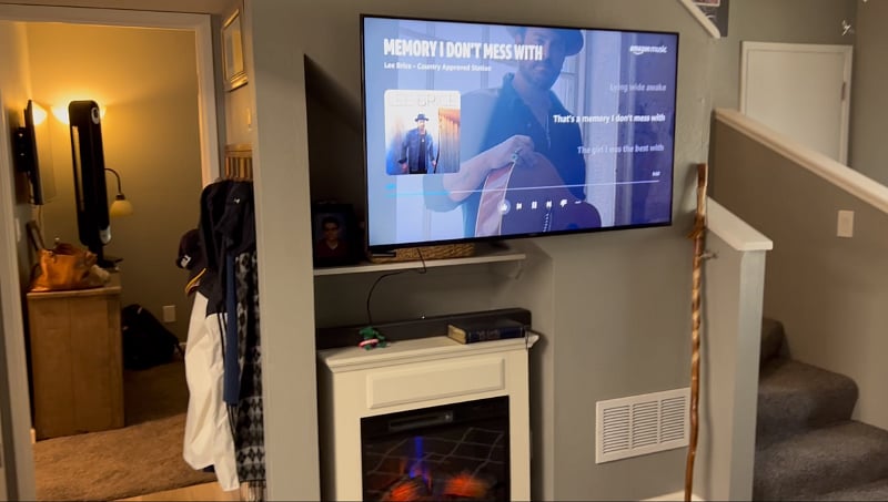 Living room with large Smart TV, soundbar and Electric fireplace