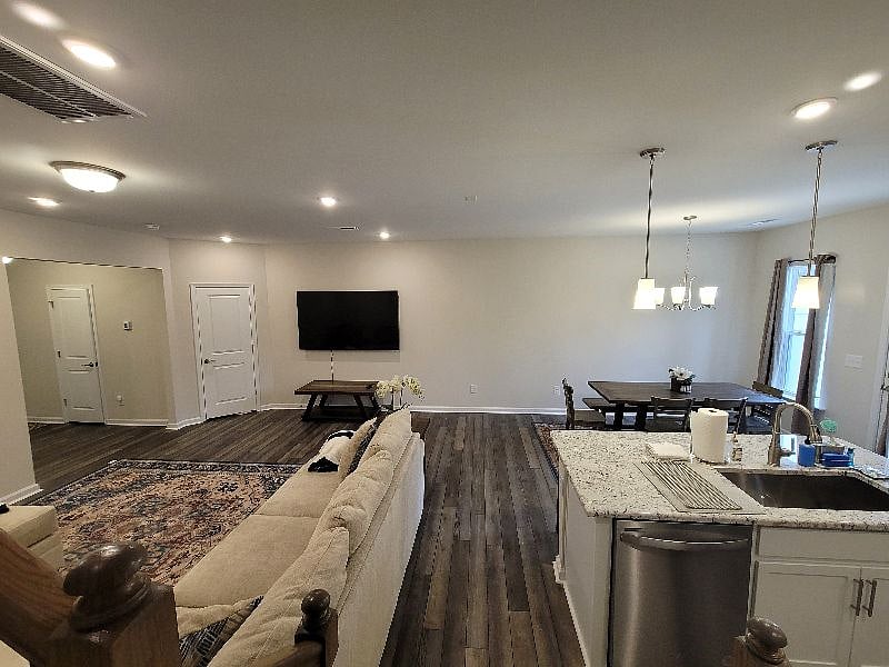 Comfy and open living space with sofa bed, eat-in kitchen, and kitchen with all essentials and a 75 inch large screen TV.