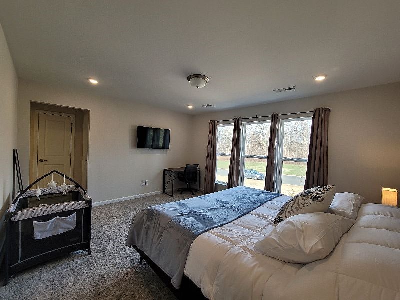 Master Bedroom with Crib as needed, work space, personal smart TV, with en suite deluxe bathroom with all essentials, and walk-in closet.