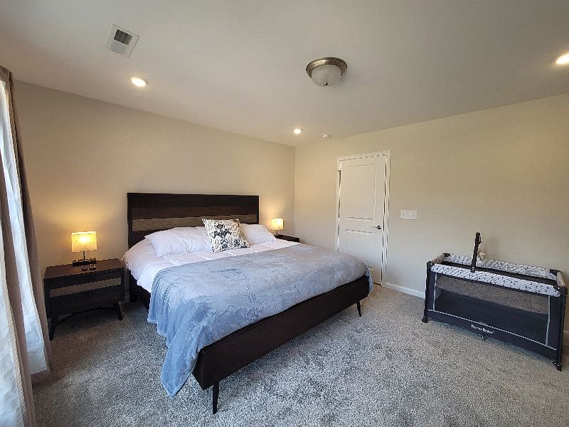 Master Bedroom with Crib as needed, work space, personal smart TV, with en suite deluxe bathroom with all essentials, and walk-in closet.