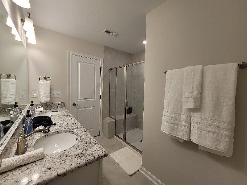 Master Bedroom with Crib as needed, work space, personal smart TV, with en suite deluxe bathroom with all essentials, and walk-in closet.