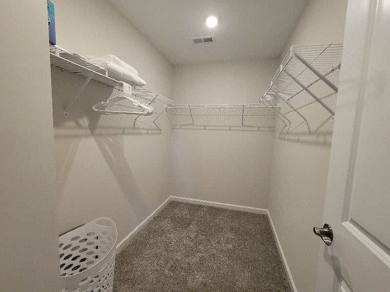 Master Bedroom with Crib as needed, work space, personal smart TV, with en suite deluxe bathroom with all essentials, and walk-in closet.
