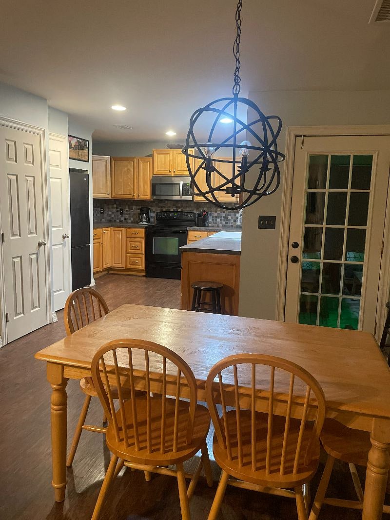 Dining room and table in an open floor plan that flows between the kitchen and living room