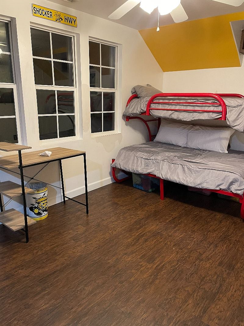 Upstairs bedroom with full and twin bunk beds, desk and built in book shelves