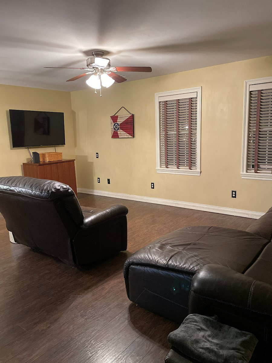 Living room with oversized recliner, couch including chaise and Roku TV.