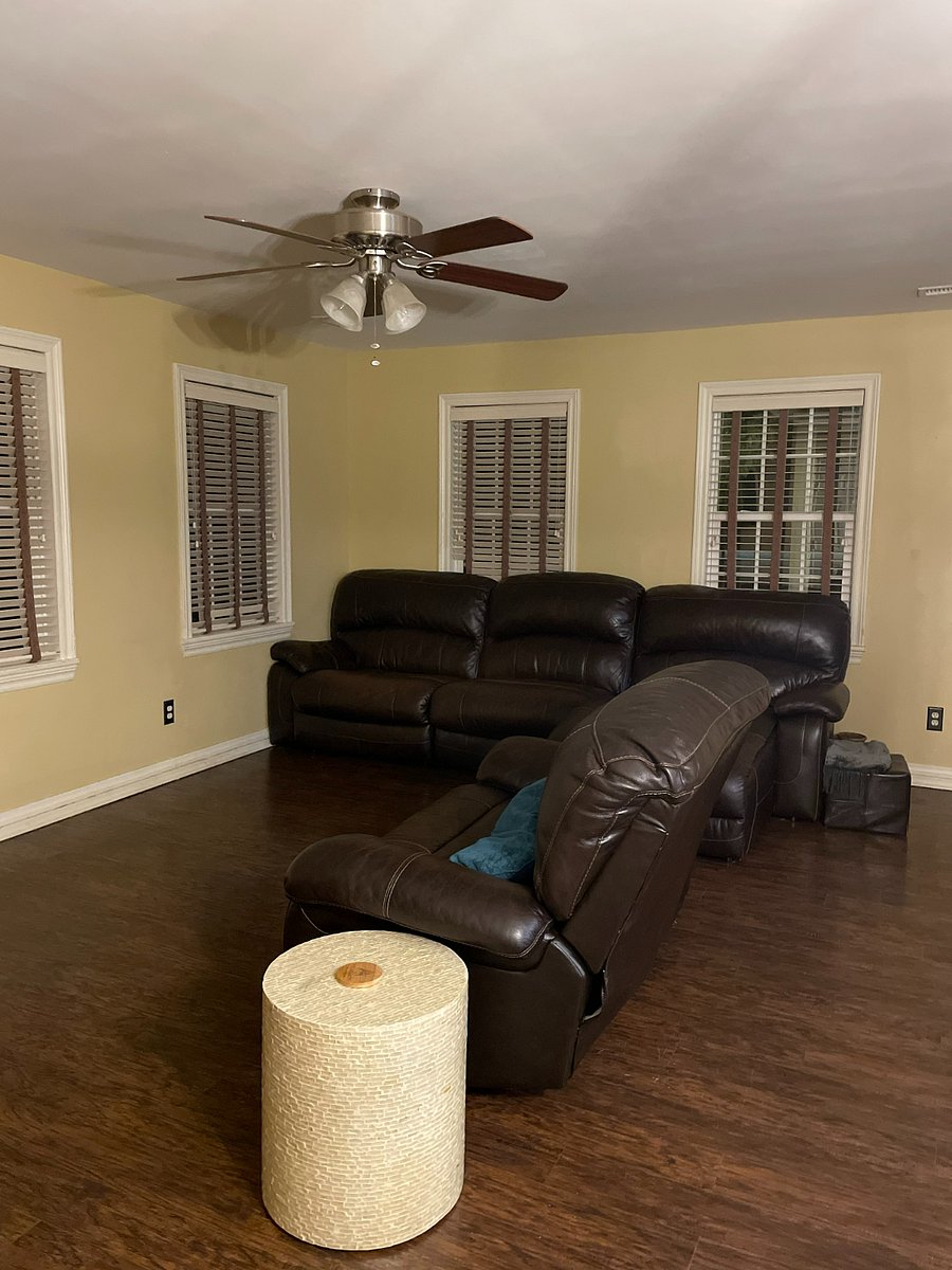 Living room with oversized recliner, couch including chaise and Roku TV.