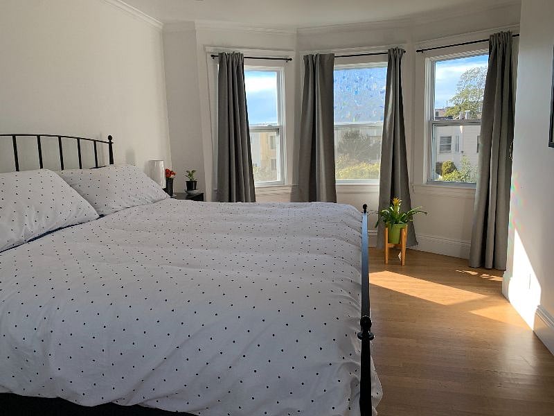 Upstairs bedroom with king bed, full bathroom in hall, access to roof-deck, 