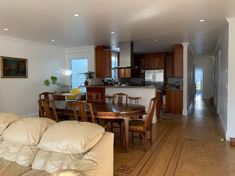 Living room with view into dining room and kitchen. 