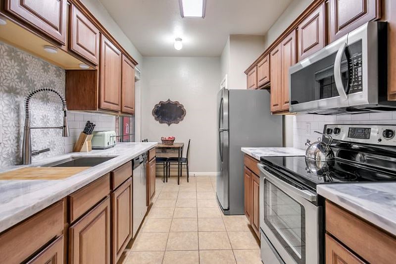 Large updated kitchen with quartzite counters. Lots of cabinets and counter space and stocked with all the essentials and the extras!
