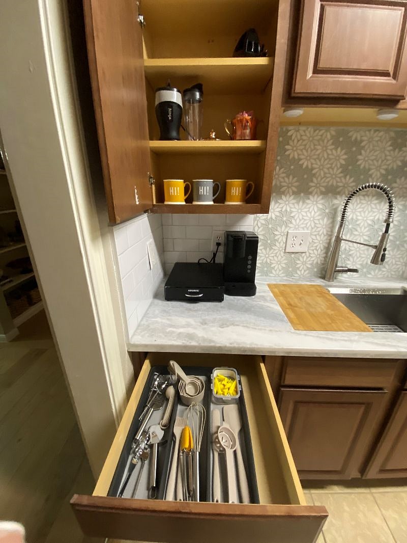 Lots of cooking utensils and full coffee station.