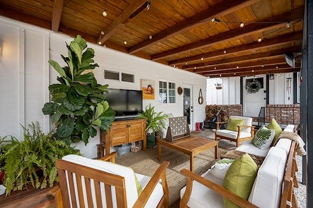 Comfy Conversation area features couch and chairs, 50" TV and electric heaters.