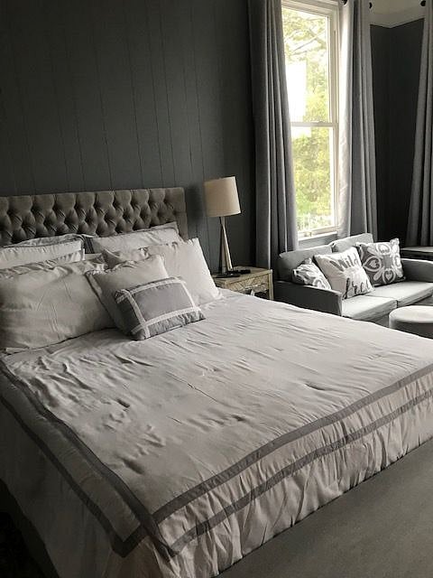 pretty bed and sitting area.  3 newly installed, large windows add to the beauty and ambience of this  upscale suite/apartment. Windows offer beautiful views as well as easy opening and closing to enjoy in the spring and fall.