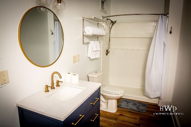   The bathroom is very large and is absolutly beautiful.  It features a nice walk in shower, a pretty blue vanity, and lots of windows for plenty of natural light.