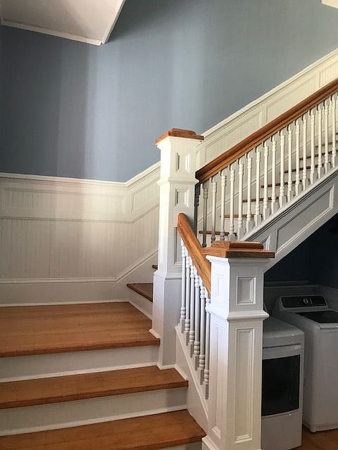 well lit grand stair case up to the large suite/apartment.