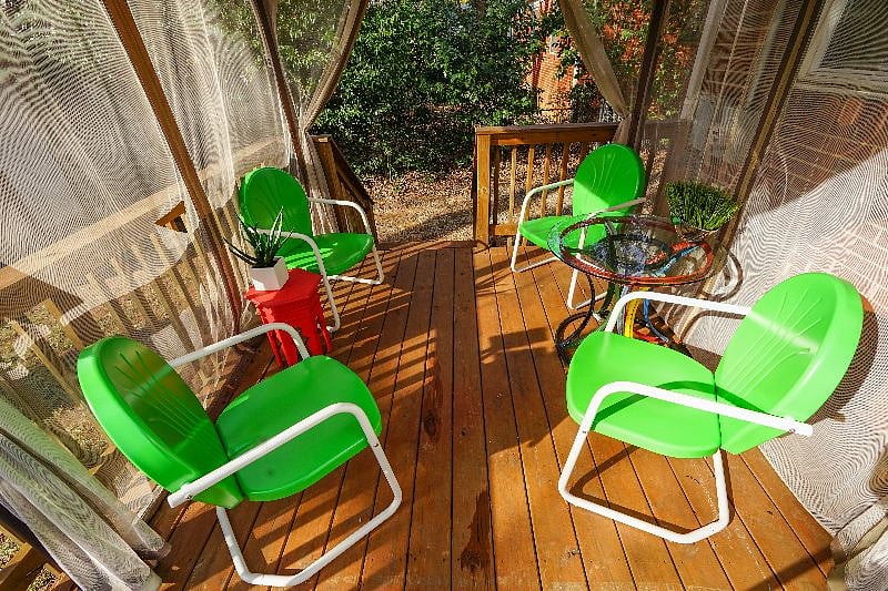 Shady Seating Area with Recycled Bicycle Parts Table Base and Glass Top. Overlooks Big Back yard.