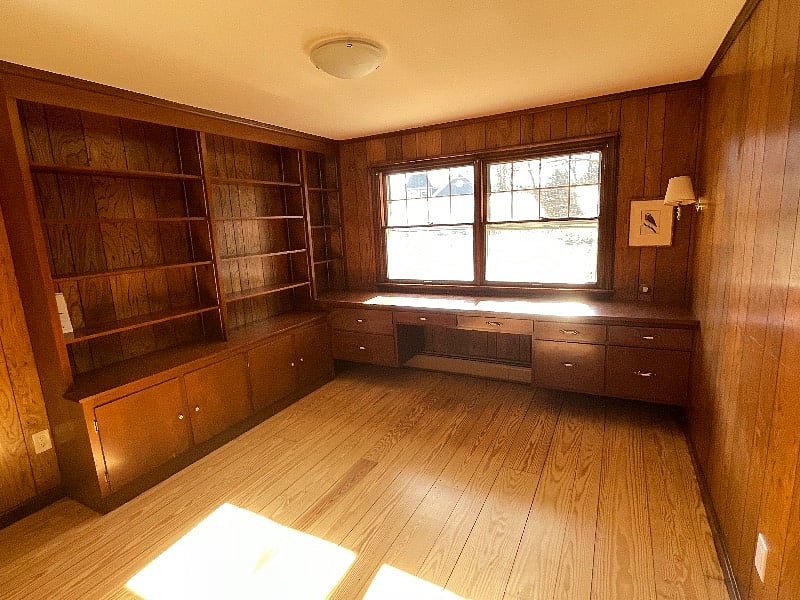 Paneled study with desk and large closet.