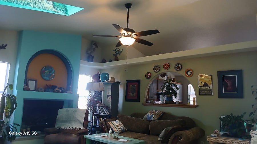 My living room area has skylights and a vaulted ceiling with new hanging fan and lighting.  The living room also has a cozy fireplace and two Vintage sofas and tile flooring a very comfortable room my favorite room.