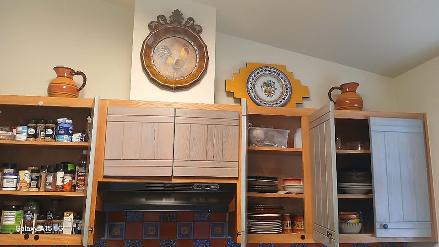 This is my kitchen cabinets full of spices and dishware that all at your disposal to use as you cook your own food dishes in my modern kitchen where you have a full sized Frigidaire refrigerator of your own to use in kitchen next to my refrigerator.