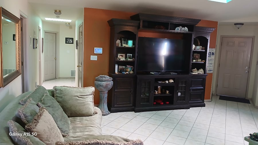 This is a photo of my living room entertainment center that is full of family photos and artifacts and fossils from the ocean which is another hobby of mine.  Also, you'll notice an indoor fountain that sounds great when on.