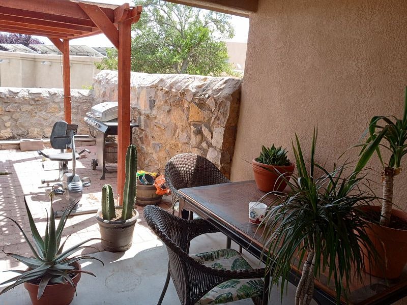 Backyard has a pergola, bbq, fountain and outdoor furniture at your disposal.