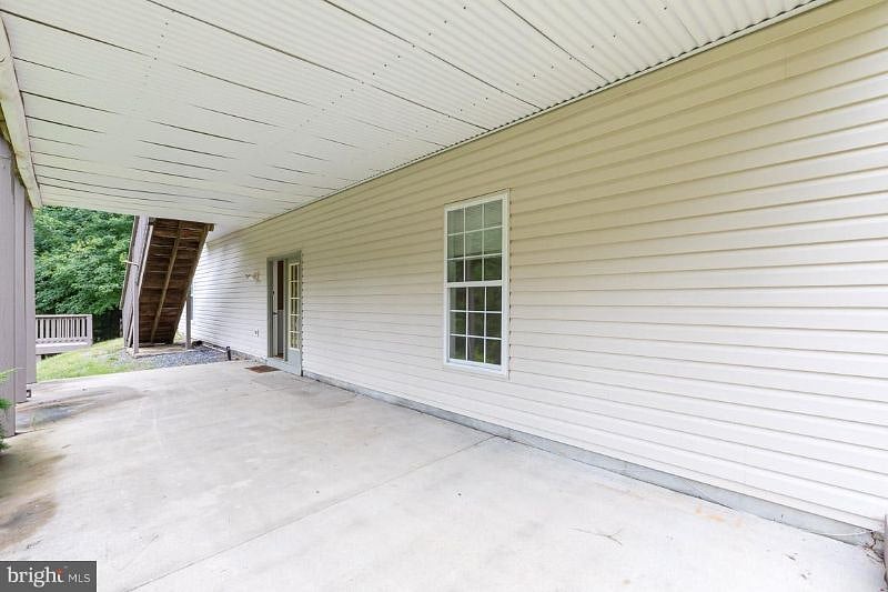 Rear patio leads to private suite entrance.