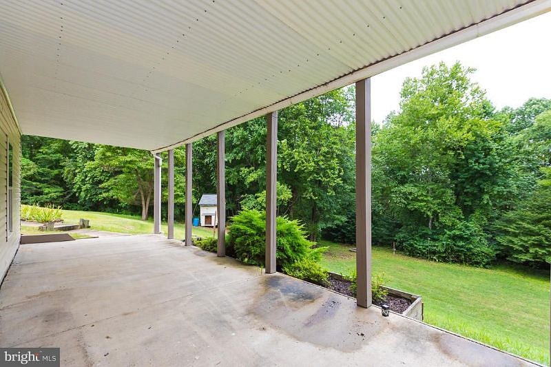 Rear patio and private suite entrance is accessed by stairs from the driveway.