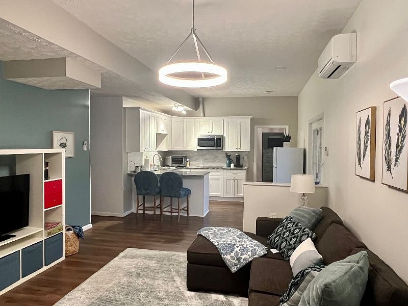 View of the living room and kitchen from the 2nd bedroom.