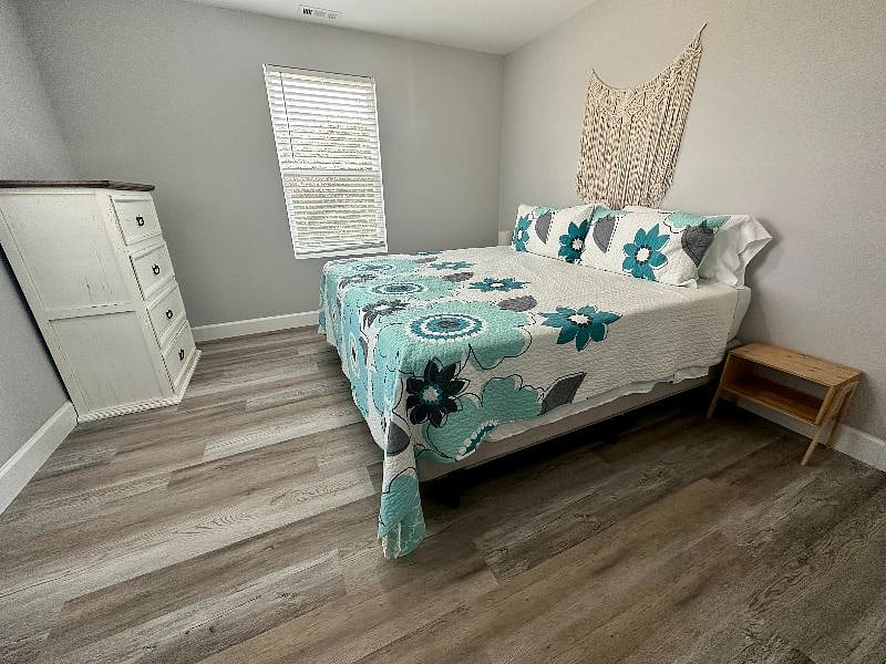 Bedroom 1 has a King bed, dresser, night stands and alarm clock