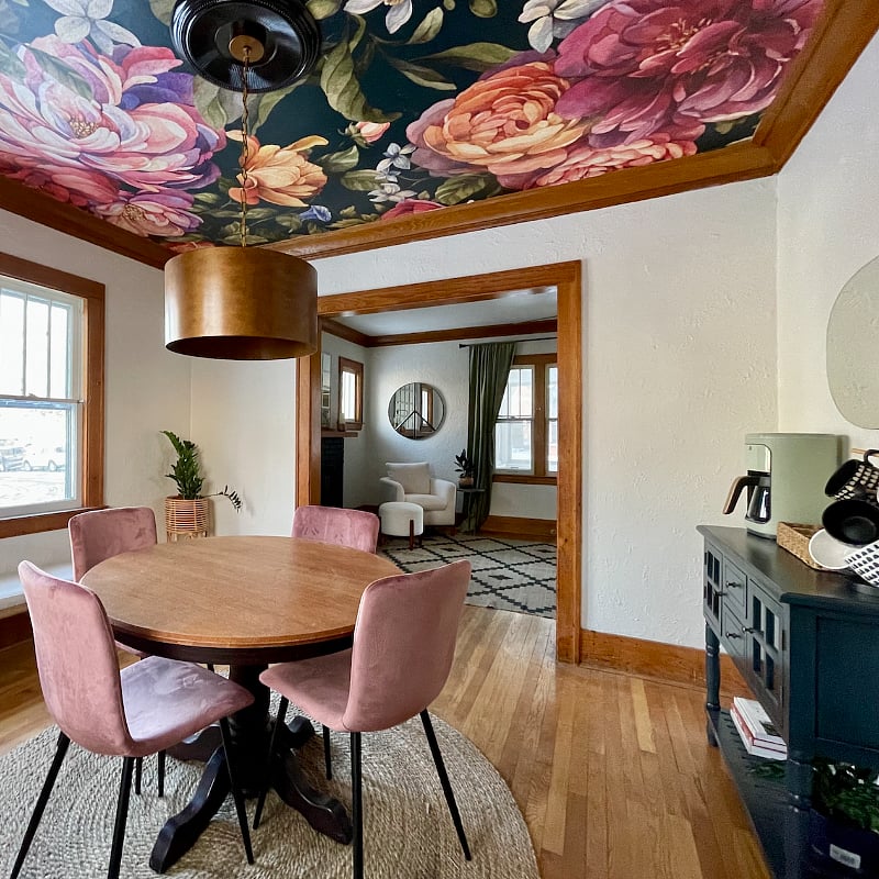 Dining area has table and 4 chairs with bench for extra seating.